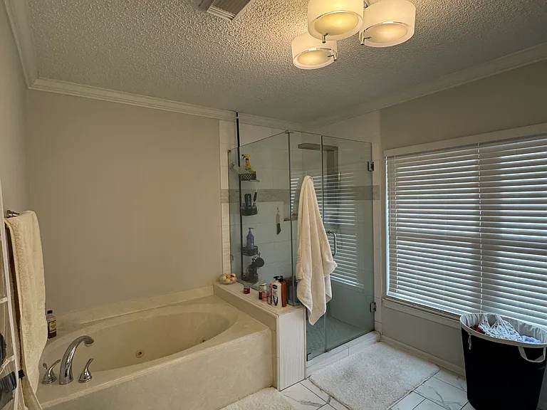 Large Master bathroom with jetted tub and new frameless walk-in shower and new tile floor
