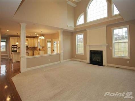 Soaring ceilings in the two story family room.   Professionally cleaned carpets & neutral decor .