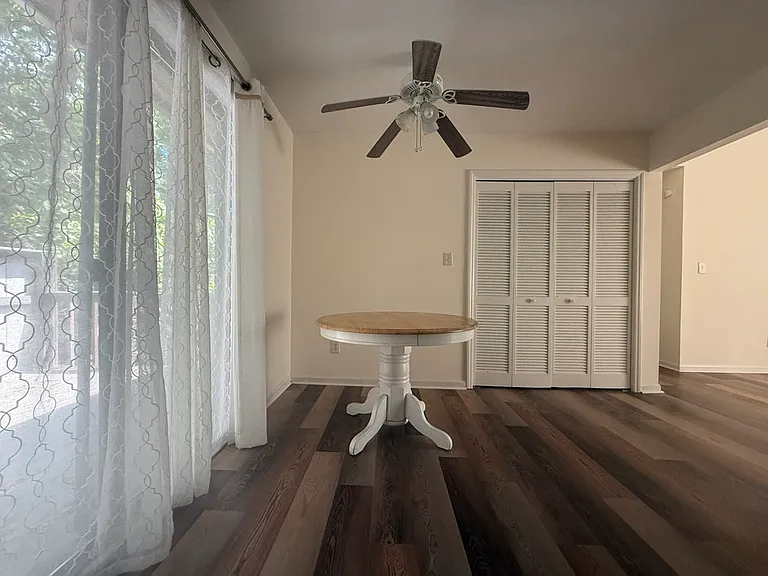 This is the view from the kitchen. The slider leads out to a private deck. The bi-fold doors conceal the laundry area