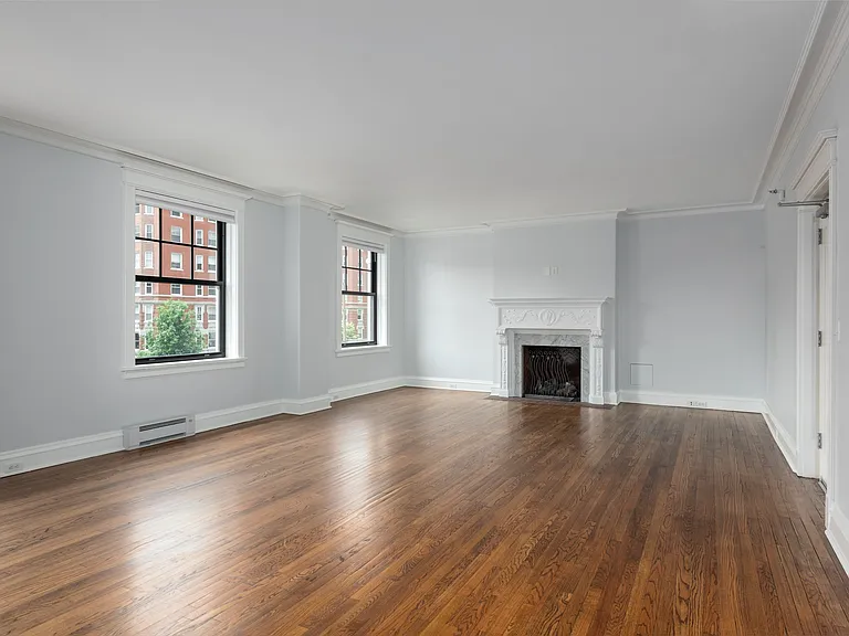York House large living room with oak hardwood flooring, gas fireplace and crown molding.