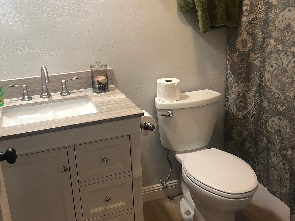 Bathroom off bedroom with new toilet, faucet and cabinet