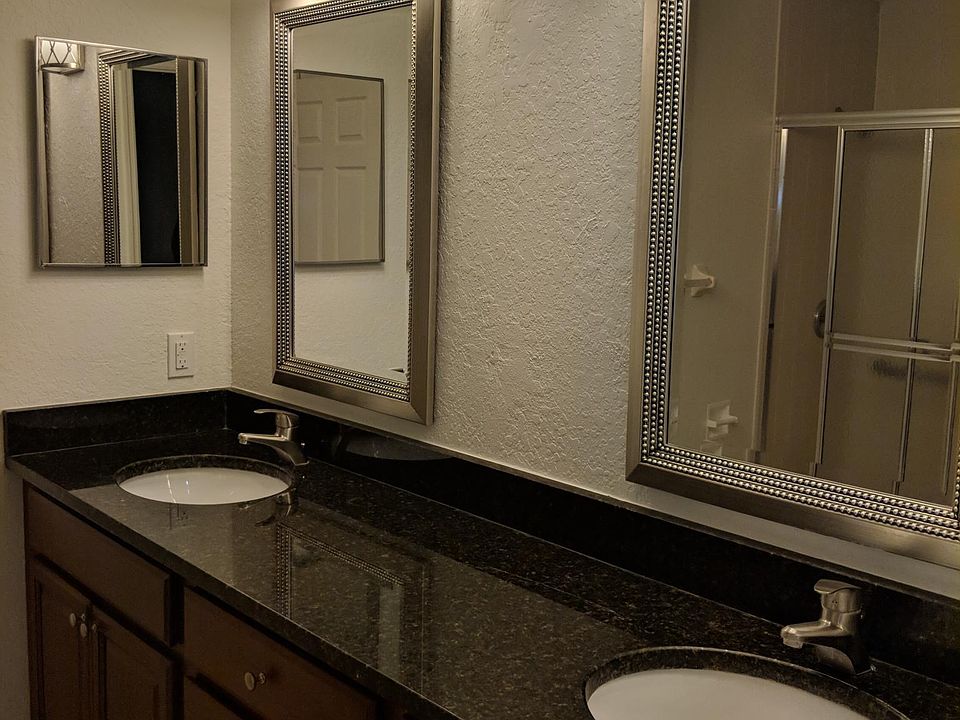 Master bathroom with granite counter top, double sink, shower seat w/grab bar