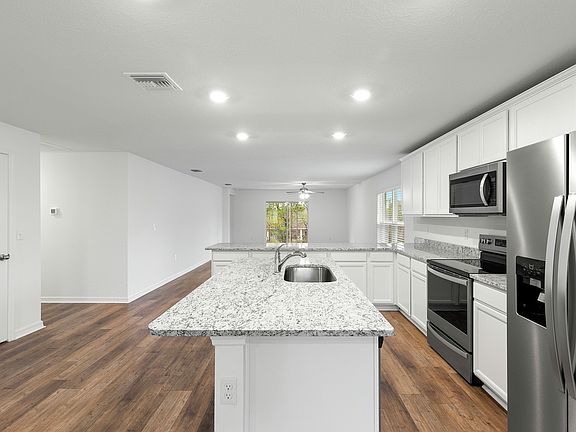 The kitchen is chef-ready with stainless steel appliances