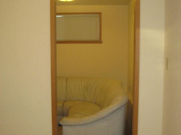 Doorway from bedroom to living room, also carpeted.