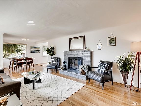 The living room has beautiful wood floors, coved ceilings and a great flow right into the dining area and kitchen. 