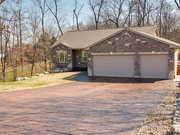 3 Car Over-sized Garage with stamped concrete drive.