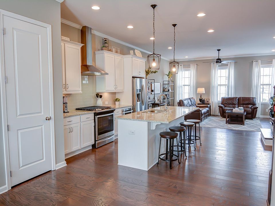 Bright open-concept layout with chef's kitchen and natural light throughout.