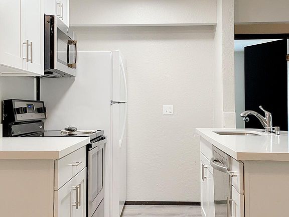 Newly renovated kitchen. Quartz countertop, cabinets, lighting and stainless appliances.
