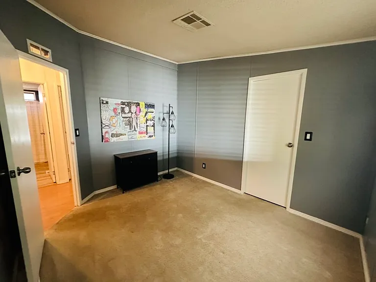 Second bedroom. Small lightweight dresser and floor lamp.