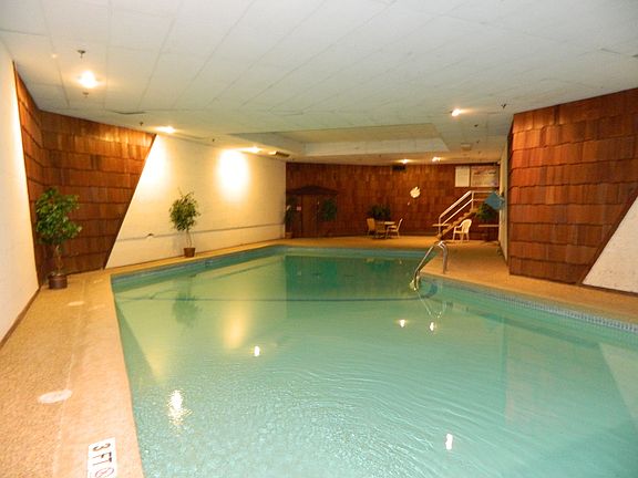 Spacious Pool and deck area next to your heated garage.  All in one building!