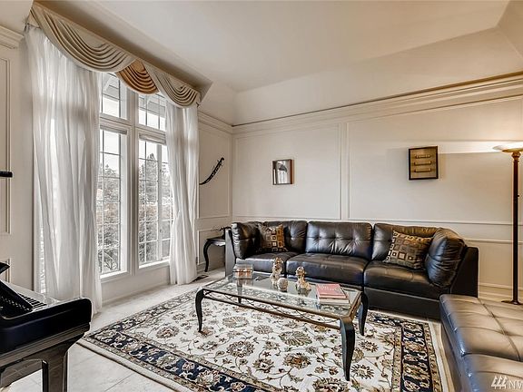 Tall ceilings, nearly floor to ceiling windows and coffered ceilings in the formal living room