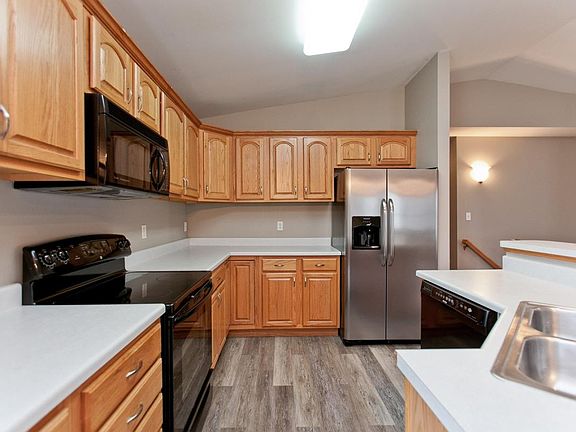 Newer stainless steel fridge with ice and water in the door and newer stainless range and microwave.
