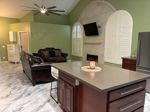 Looking from kitchen, over kitchen island, to living room.