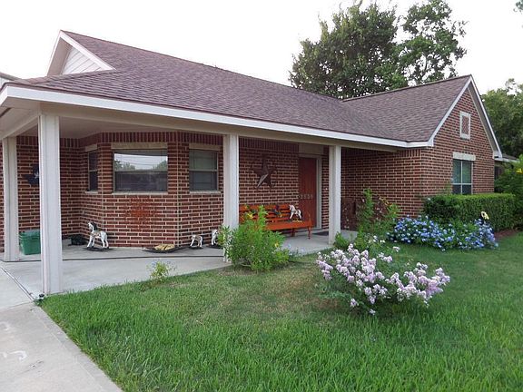 2013 picture, Front porch area is clean and attractive. Tree