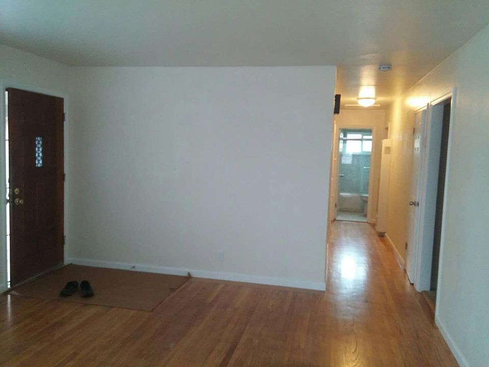 Living room facing front door + hallway