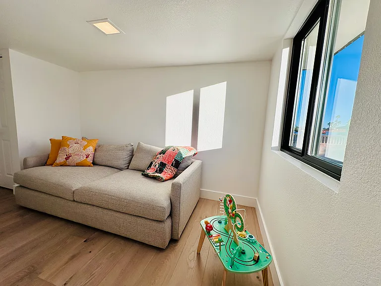 Kid's room featuring a spacious sofa that effortlessly converts into a comfortable bed...