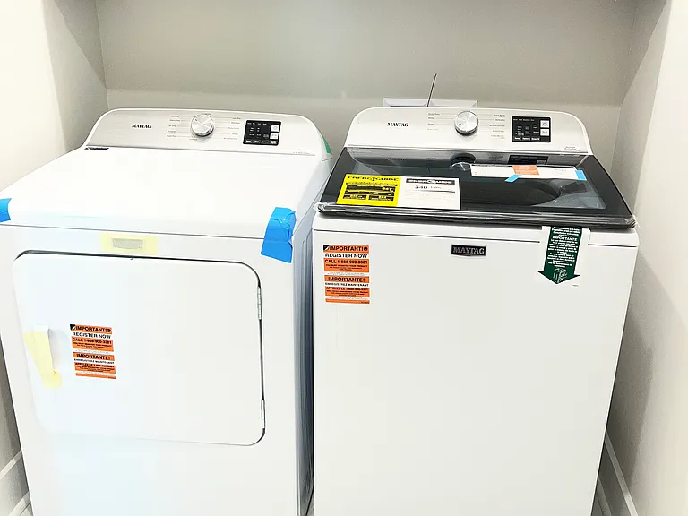 Laundry room with new washer and dryer