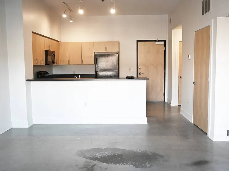 Living room and kitchen view in a unit at The Sawyer.