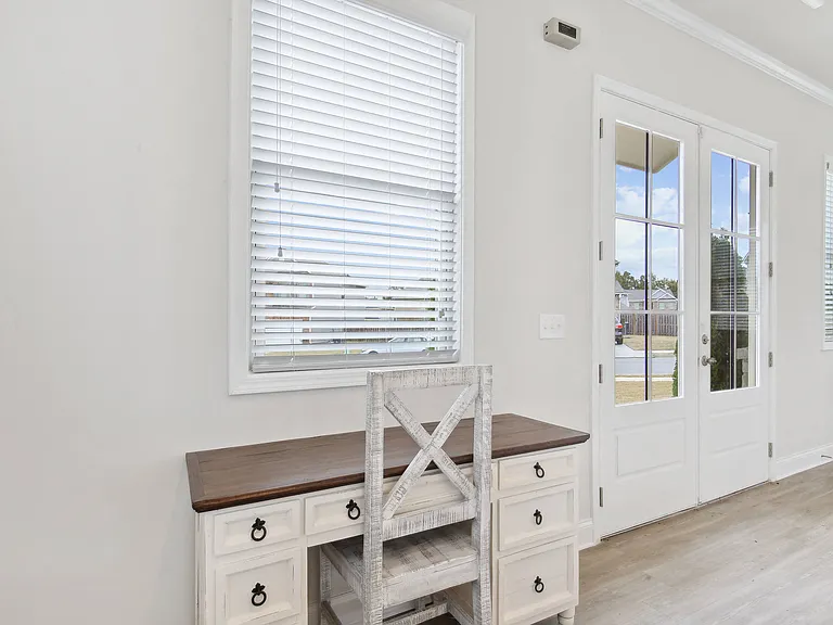Bright workspace featuring a white desk with built-in drawers