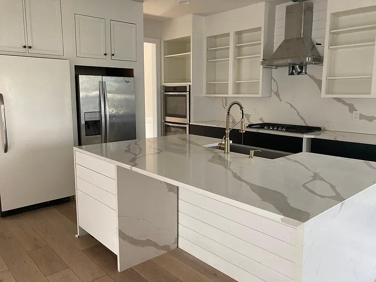 Kitchen with quartz countertop - standalone freezer - standalone fridge - double ovens - and more!
