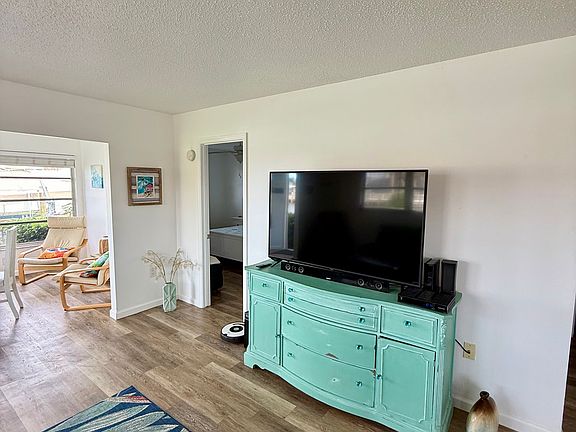 Living Room features a big flat screen TV, perfect setup for entertainment and relaxing.
