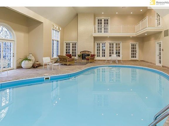 Spacious heated pool room also has a fireplace for cozy winter swims.