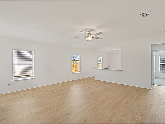 Three windows bring in plenty of natural light into the family room and kitchen