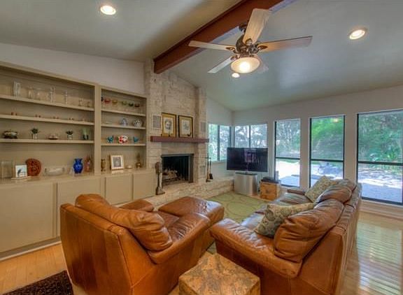 Wall of built-in bookshelves.  Hidden access for entertainment equipment within the bookshelves.