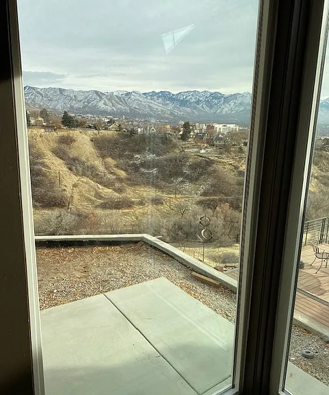 View out Back window of city creek and Wasatch Mountains