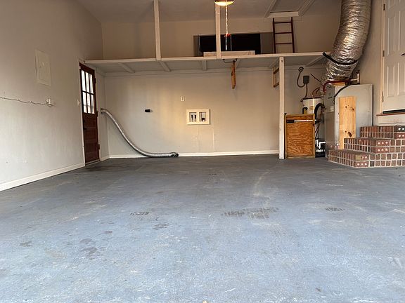 2 car garage with overhead storage and attic access. Side door on left opens up to backyard. Door on right allows access to the home.