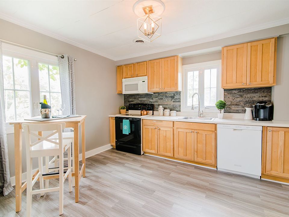 Kitchen with new flooring, faucet, paint and lighting featur