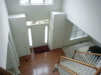 Two story hardwood entrance foyer w/twin closets
