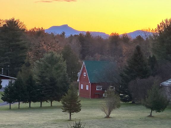 Camels Hump is seen from the kitchen and LR windows on the east side. The red barn is on the neighbor's land, about 400 ft distant.