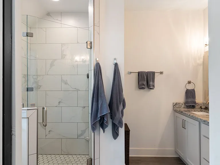 Beautifully tiled floors and a walk-in shower lend a spa-like feel.