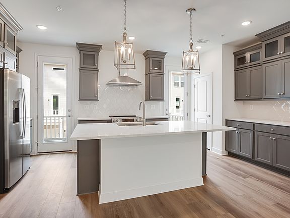 Kitchen with dual doors to deck for seamless indoor-outdoor living