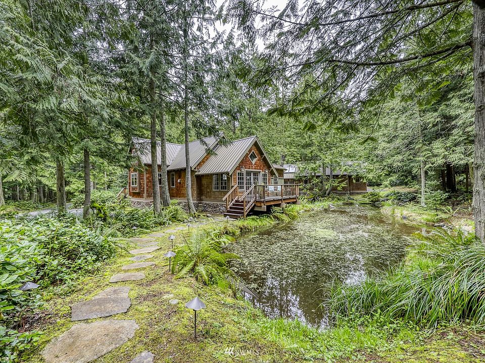 40 Saddle Drive is located in the community of Cape George Highlands. The ~5-acre parcel is filled with lush vegetation and towering cedars.  