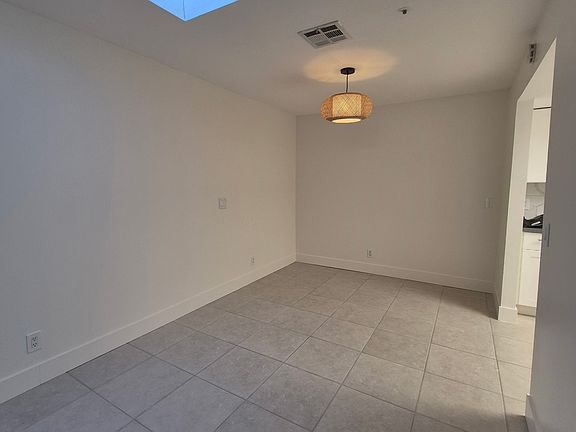 View of dining area and kitchen to the right.