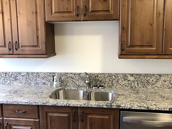 Kitchen with knotty alder cabinets and granite counter tops