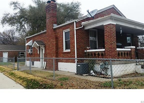 Cute brick house with a large covered front porch.