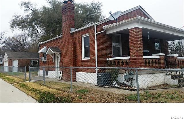 Cute brick house with a large covered front porch.