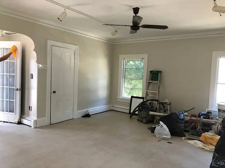 So Sunny and Spacious with ceiling fan in this amazing living room!