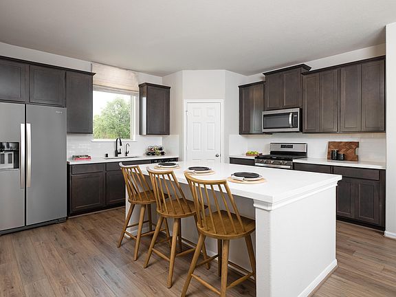 The kitchen features a large center island with overhang perfect for a breakfast bar and a walk-in p