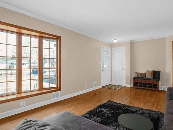 Front room with bay window, looks out towards front lawn and Warner Rd. Easy view for school bus stop at driveway.