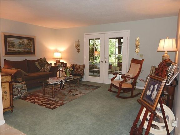 Spacious Living Room with French Doors that lead out to the Covered/Screened Lanai