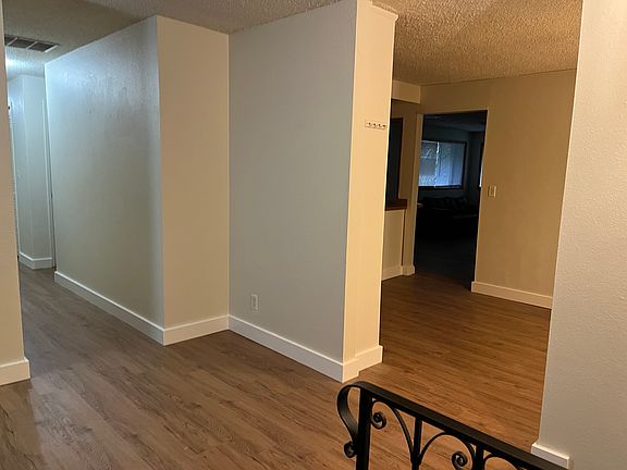 Living room entry with view to the kitchen and dining area with the family room beyond.
