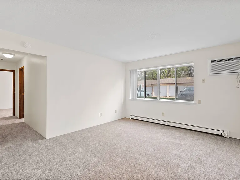 Living room with wall unit air conditioning