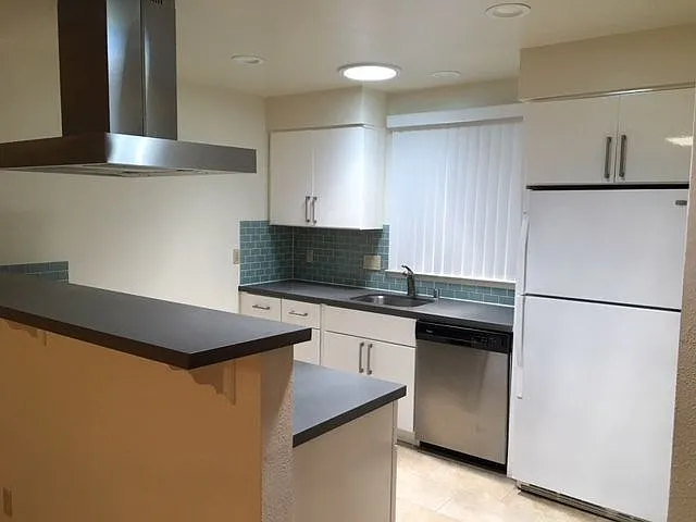 Open Plan Kitchen with Quartz counters and stainless steel applicances