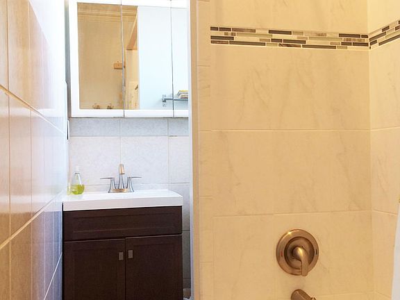 Newer tile & vanity in bathroom