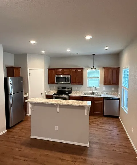 Loads of counterspace and storage in this kitchen with stainless steel appliances!