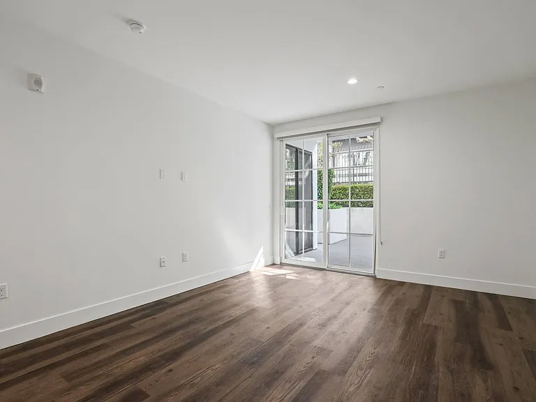 Spacious Bedroom with Patio, Vinyl Flooring, and Recessed Lighting